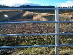 Galvanized tube rail installed by valley fence